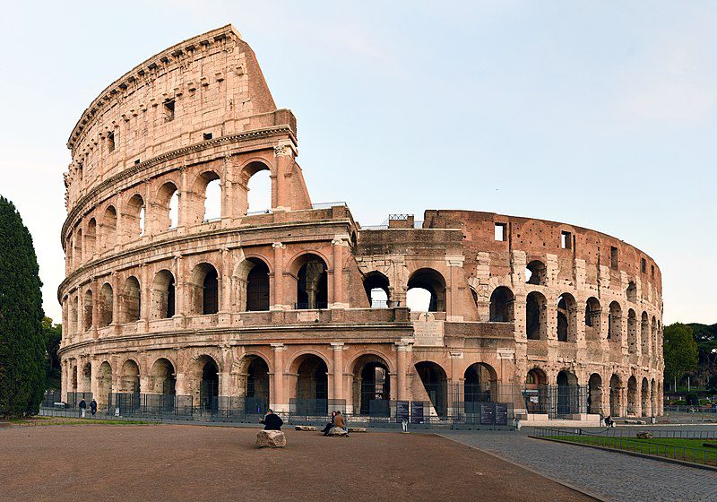 A large building with arches and columns in the middle of it.