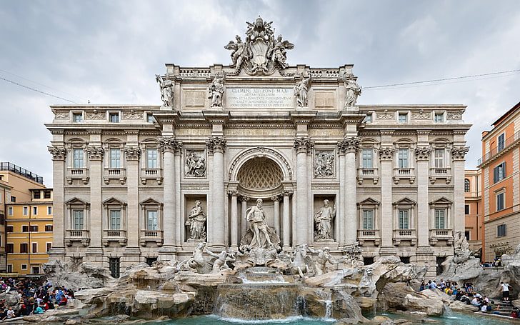 A large building with many statues in front of it