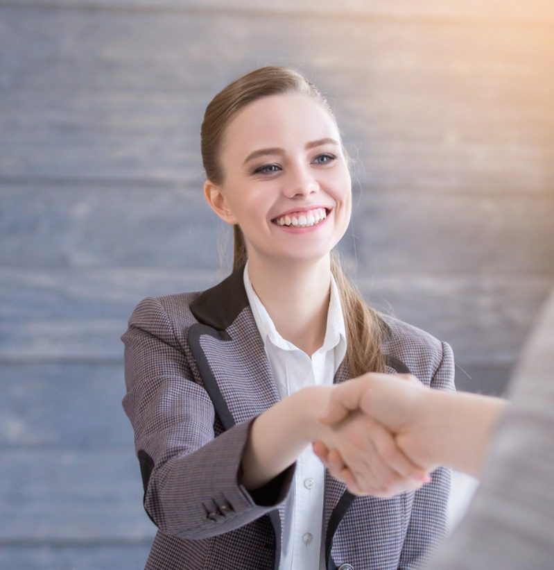 A woman shaking hands with another person.