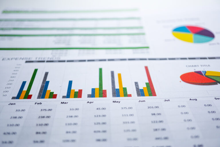 Close-up of colorful bar charts and graphs on printed paper.